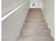 Carpeted stairs with a white railing leading to the next level of the home at 3975 N Hualapai Way # 235, Las Vegas, NV 89129