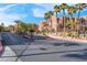 Street view of the community showcasing well-maintained landscaping and attractive building exteriors at 3975 N Hualapai Way # 235, Las Vegas, NV 89129