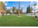 Beautifully landscaped yard with palm trees and large lush green lawns at 401 Lacy Ln, Las Vegas, NV 89107