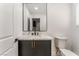 Modern powder room showcases a black vanity, marble countertop, and sleek fixtures at 401 Lacy Ln, Las Vegas, NV 89107