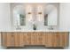 Bright bathroom with dual sinks, modern faucets, quartz counters, and wooden drawers at 401 Lacy Ln, Las Vegas, NV 89107