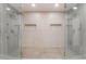 A large tile shower with dual shower heads, and inset shelves in this bathroom at 401 Lacy Ln, Las Vegas, NV 89107