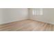 Bright bedroom features wood-look flooring and a window with white shutters at 401 Lacy Ln, Las Vegas, NV 89107