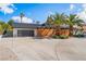 Charming single-story home with a modern garage and decorative wooden fence and beautiful palm trees at 401 Lacy Ln, Las Vegas, NV 89107