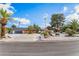 Beautiful single-story home boasting mature landscaping and well manicured desert flora at 401 Lacy Ln, Las Vegas, NV 89107