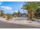 Beautiful single-story home boasting mature landscaping and well manicured desert flora at 401 Lacy Ln, Las Vegas, NV 89107