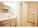 Bathroom with single vanity and mirror adjacent to linen closet at 4032 Great Plains Way, Las Vegas, NV 89121