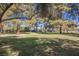 Lush green common area with mature shade trees providing a serene environment at 4032 Great Plains Way, Las Vegas, NV 89121