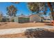 Inviting home exterior featuring green fence, rock landscaping, and cozy residential charm at 4032 Great Plains Way, Las Vegas, NV 89121