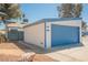 A lovely single story home showcasing a blue garage door and xeriscaped front yard at 4032 Great Plains Way, Las Vegas, NV 89121