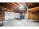 Spacious garage with a large door, ample lighting, and extra storage racks for organization at 4032 Great Plains Way, Las Vegas, NV 89121