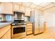 Updated kitchen featuring stainless steel appliances, light wood cabinets, and hard surface floors at 4032 Great Plains Way, Las Vegas, NV 89121