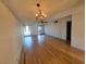 An open-concept living room featuring hardwood floors, fan and neutral paint at 4032 Great Plains Way, Las Vegas, NV 89121
