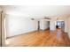 Open living room showcasing wood floors, neutral paint, and views to the kitchen at 4032 Great Plains Way, Las Vegas, NV 89121