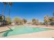 A refreshing community pool under a clear blue sky with tall palm trees at 4032 Great Plains Way, Las Vegas, NV 89121