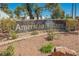 Elegant community sign that reads 'American Village' set amongst desert landscaping at 4032 Great Plains Way, Las Vegas, NV 89121