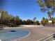 Outdoor basketball court surrounded by lush greenery for recreational activities and sports at 405 Center Green Dr, Las Vegas, NV 89148