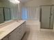 Bathroom featuring a soaking tub, separate glass-enclosed shower and dual sink vanity at 405 Center Green Dr, Las Vegas, NV 89148
