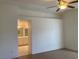 A main bedroom featuring an attached ensuite bath, a ceiling fan and wood-look floors at 405 Center Green Dr, Las Vegas, NV 89148