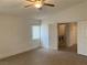 Bright bedroom with wood-look flooring and a ceiling fan, plus a doorway to the laundry area at 405 Center Green Dr, Las Vegas, NV 89148