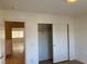 Bedroom featuring an open closet with sliding doors and a doorway to another area at 405 Center Green Dr, Las Vegas, NV 89148
