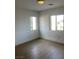 Bedroom with two windows offering an abundance of natural light and wood-look flooring at 405 Center Green Dr, Las Vegas, NV 89148