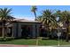 View of community building featuring stone accents, mature landscaping, and palm tree surroundings at 405 Center Green Dr, Las Vegas, NV 89148