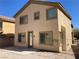 An exterior view of the home showing the beige stucco and upper and lower windows at 405 Center Green Dr, Las Vegas, NV 89148