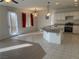 A spacious kitchen features tile floors, white cabinets, an island, and stainless steel appliances at 405 Center Green Dr, Las Vegas, NV 89148