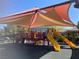 Bright and colorful playground with slides and climbing structures under a shaded canopy at 405 Center Green Dr, Las Vegas, NV 89148