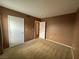 A carpeted bedroom featuring neutral walls and white doors at 45 Maleena Mesa St # 1921, Henderson, NV 89074