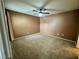 A carpeted bedroom featuring neutral walls and a ceiling fan at 45 Maleena Mesa St # 1921, Henderson, NV 89074