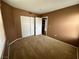A carpeted bedroom featuring neutral walls, a ceiling fan and closet at 45 Maleena Mesa St # 1921, Henderson, NV 89074