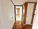 Hallway with wood floors leads to bedrooms and other areas of the home at 45 Maleena Mesa St # 1921, Henderson, NV 89074