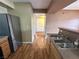 Kitchen with stainless steel refrigerator, double basin sink, and laminate flooring at 45 Maleena Mesa St # 1921, Henderson, NV 89074
