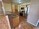 Kitchen featuring stainless steel appliances, wood cabinets, and laminate floors at 45 Maleena Mesa St # 1921, Henderson, NV 89074