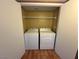 A laundry room features a white washer and dryer and wire shelving at 45 Maleena Mesa St # 1921, Henderson, NV 89074