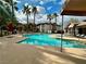 Inviting community pool with surrounding palm trees and ample seating areas at 45 Maleena Mesa St # 1921, Henderson, NV 89074