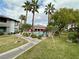 Community pool area with palm trees, lounge chairs, and manicured landscaping at 45 Maleena Mesa St # 1921, Henderson, NV 89074