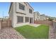 Backyard features a brick patio, artificial grass, privacy wall, and rock landscaping for a low-maintenance space at 4727 Agave Cactus St, North Las Vegas, NV 89031