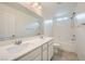 Bathroom featuring double sinks, large mirror, modern lighting fixtures, and shower-tub combo at 4727 Agave Cactus St, North Las Vegas, NV 89031