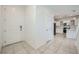 Bright entryway showcasing tiled floors and white walls leads to the home's kitchen at 4727 Agave Cactus St, North Las Vegas, NV 89031