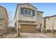 Charming home featuring a two-car garage, brick driveway, stylish shutters, and manicured landscaping at 4727 Agave Cactus St, North Las Vegas, NV 89031