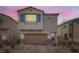 Charming home featuring a two-car garage, brick driveway, stylish shutters, and manicured landscaping at 4727 Agave Cactus St, North Las Vegas, NV 89031