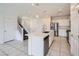 Modern kitchen featuring an island with a sink and a view of the stairway to the second floor at 4727 Agave Cactus St, North Las Vegas, NV 89031