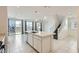 Modern kitchen features an island with sink and stainless steel dishwasher overlooking the backyard at 4727 Agave Cactus St, North Las Vegas, NV 89031