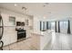 Modern kitchen features stainless steel appliances, a large island and an adjoining living space at 4727 Agave Cactus St, North Las Vegas, NV 89031