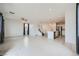 Bright living room featuring tile floors that flow into the kitchen with stainless appliances at 4727 Agave Cactus St, North Las Vegas, NV 89031