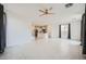 Open-concept living room with tile flooring leading to a modern kitchen at 4727 Agave Cactus St, North Las Vegas, NV 89031