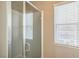 Bathroom boasts a tiled shower stall and a window with privacy blinds at 5505 High Wager Way # 102, Las Vegas, NV 89122